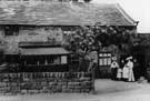 Family group at cottages on Towngate Road, Worrall