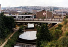 Supertram travelling across the Supertram bridge over the Sheffield and South Yorkshire Navigation, with Spartan Steel and Alloys, Spartan Steelworks on Attercliffe Road in the background, 1994