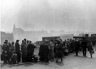 The 'Holidays at Home' scheme, World War 2.  People waiting for buses to take them to local parks, 1943