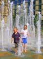 Children playing in the Peace Gardens fountains
