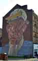 View: a01169 Brickwork Mosaic entitled 'Steelworker', on the gable end of a four-storey building on Castle Street. 