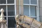 Carved lion's head on the broken pediment of the entrance to the Alexandra Hotel on Castlegate