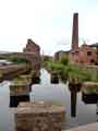 View of Kelham Island showing derelict buildings on the left, and on the right the chimney of the former Russell Works of Wheatman and Smith, steel refiners and manufacturers. 2013
