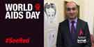 Sheffield Councillor Mazher Iqbal commemorates World Aids Day by wearing a red ribbon