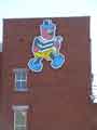 View: a04500 Bertie Bassett, the brand mascot of Cadbury Sheffield (formerly Geo. Bassett and Co.), confectionary manufacturers on the wall of their factory, Dutton Road