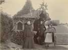 Three ladies (one in a bath chair) in an unspecified park or recreation ground