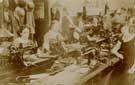 Group of what appears to be factory women at sewing machines