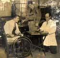 Painted Fabrics T. Llewellyn in wheelchair; Billie Whitham standing and Arthur Fisher on right.