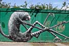 Street art, artwork on wooden fence on Sylvester Street by Phlegm