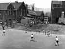 View: s24610 Rounders match in the playground at Park Junior and Infant School, Duke Street formerly Park County School with Duke Street Flats and Hyde Park Flats in the backgound
