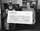 Presentation of cheque for new computer equipment for Walkley Library by Walkley Library Action Group