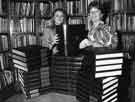View: s31938 Pat Coleman (right), Director of Libraries, presenting a set of Encyclopedia Britannica's to a competition winner at Central Library, Surrey Street