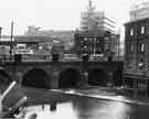 View: s33259 Lady's Bridge as seen from Castlegate showing Tennant Brothers Ltd, Exchange Brewery (right), Bull and Mouth public house, and Sheaf Market (centre and back) 