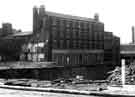 View: s33671 Arnold Carter and Co. Ltd., builders and plumbers merchants, Trinity Works, Eyre Street and the junction with Furnival Street during road construction 
