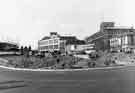 Construction of Sheaf Square roundabout looking towards Arthur Davy and Sons Ltd., provision merchants, Paternoster Row (right) and Kenning Motor Group showroom, Leadmill Road (centre)