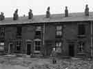 Arthur Britton outside his home, the only occupied house in a row of derelict terrace houses