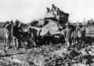 Troops of 272 Field Company lay a foundation of bricks to help a tank bogged down in thick mud, probably in Italy
