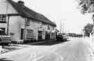 Shops on Greenhill Main Road showing (left to right) Williams, Knibb and Co., insurance services and the Village Shop