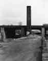 Old industrial chimney, Sheaf Works next to the canal at the end of Blast Lane, Nunnery showing the Victoria Station viaduct behind