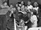 Belfast children on holiday in Sheffield having a sing song in the Scouts Hall, No.551 Fulwood Road, Fulwood