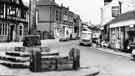 Woodhouse stocks and market cross, Cross Street showing Royal Hotel (left) and Melia's Supermarket (centre) c.1963