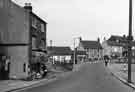 View: s41751 Market Square, Woodhouse showing E. Kendall (No.22a), shoe shop (centre), Buy Wise Supermarket (right) and the Stag Inn (far right)