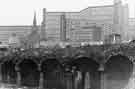 Arches at the Canal Basin being restored with Hyde Park Flats and St John's, Park (back) c.1960s