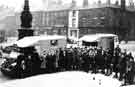 View: s43010 Group of Sheffield people who were emigrating to South Africa. They are pictured in Barkers Pool with 2 ex-army ambulances