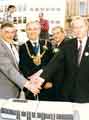 View: s43017 Lord Mayor, Councillor Peter Price cutting an anniversary cake outside the Cathedral, Church Street on the first anniversary of the opening of the Supertram route to Middlewood and Malin Bridge