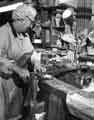 Mrs Gill operating the pulling on machine, Joseph Elliot and Sons Ltd,, Sylvester Works, cutlery manufacturers, Sylvester Street 