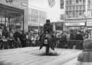Fairground attraction on Holy Green showing (centre) shops on the Moor, No.88 Lloyds Bank Ltd., and No.85 Curry's Ltd., radio and television dealers