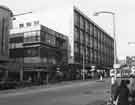 Shops on The Moor showing (left) at junction with Rockingham Way, Nos.16 - 18 Dixons Ltd., photographic equipment, audio visual and electronics store and (right) Debenhams, department store
