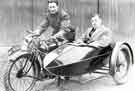 Skid Skinner and Fred Barker on motor cycle and side car