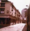 Shops on Orchard Street prior to the Orchard Square redevelopment showing the Sheffield Raincoat Stores (No.21)
