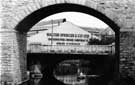 Looking through Norfolk Midland Railway Viaduct towards Norfolk Bridge and Walter Spencer and Co. Ltd.