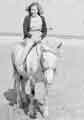 Dora Clayton riding a donkey at Cleethorpes