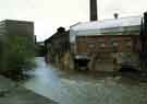 Derelict factory buildings on the River Don showing (left) Saville House