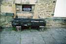 Old coffin used as a water trough outside Turret Lodge, Manor House 