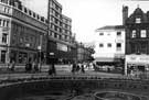 View: u08121 Top of Fargate with Goodwin Fountain in foreground, showing GT Sports (left), the Fountain Precinct: Education Department offices; H.L.Brown and Son Ltd., jewellers and Western Jean Company