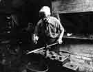 Albert Craven, forger, fashioning a sword blade at his workshop