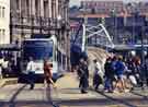 Supertram at the Fitzalan Square / Ponds Forge stop on Commercial Street showing Park Square Supertram bridge (centre)