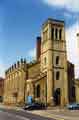 Holy Trinity Church at the junction of Nursery Street and Johnson Street (right) with the chimney of what used to be John Aizelwood Ltd,  Crown Flour Mills in the background