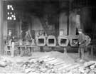 Brown Bayley's Steel Works Ltd - ingot moulds and other castings on gantry.  Mr Williams on left.