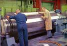 View: y04076 Inspecting a one-piece forged steel back up roll , 1950s