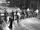 Thos. Firth and John Brown Ltd. - 8” bar mill in operation.  Forged steel rolls in use in the roughing stand.