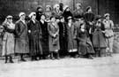 Women munitions workers at Thomas Firth and Sons Ltd., captioned 'And we - we feed the guns'