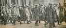 Yesterday was the day for the first batch of men in groups 6 to 9 to present themselves. A section of the men are here seen marching out of the Corn Exchange, Sheffield, for the Midland Station, en route for their training depot.