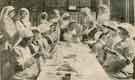 The membership of the Sheffield University War Hospitals Supply Depot now numbers about 600.  Here a group of ladies of the depot are seen making 'many-tailed' and other bandages