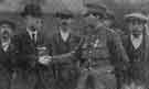 Presentation of the Military Medal and gold wristlet watch to Lance Corp. John Barstow by Mr J. A. Peace (Director of Messrs Cocker Bros, Fitzalan Works, Sheffield).  On the right is the hero's father.