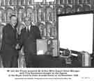 Mr Van der Plirym presents Mr Arthur Mills, export sales manager, with cine equipment bought by the Agents at the Royal Victoria Hotel Arundel Suite on 23 November 1959